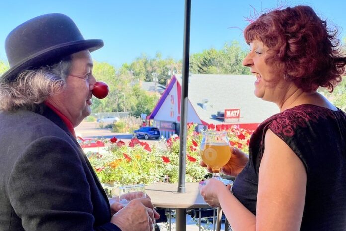 Jim Jackson and Birgitta De Pree, as Art Guffaw and Babette Matdiva, stand on the patio at Ivywild School, overlooking the Millibo Art Theatre in Colorado Springs