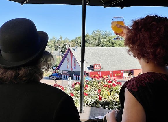 Birgitta De Pree and Jim Jackson as their characters Babette and Art Guffaw, toast the Millibo Art Theatre from the next-door patio of Ivywild School
