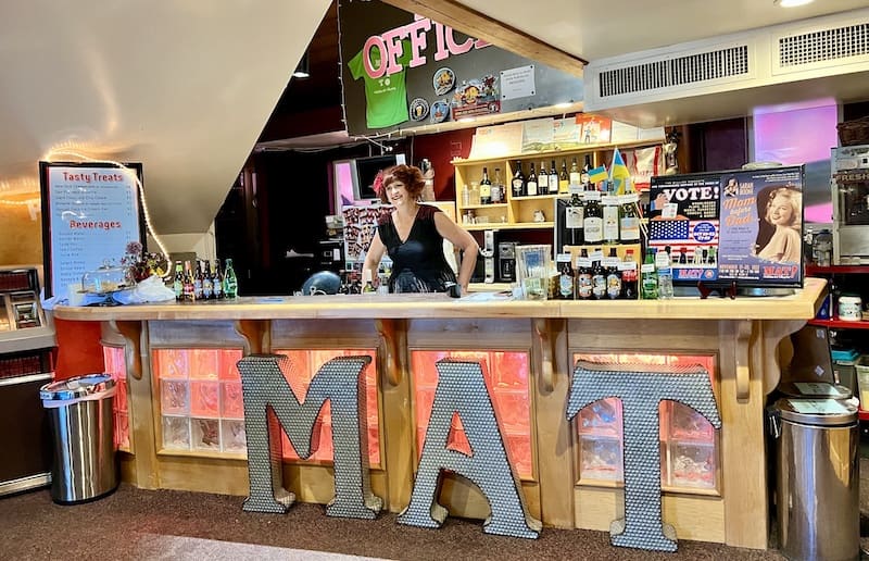 Birgitta De Pree as Babette behind the lobby bar at the Millibo Art Theatre in Colorado Springs, an entertaining and creative stop for travel with kids in Colorado Springs