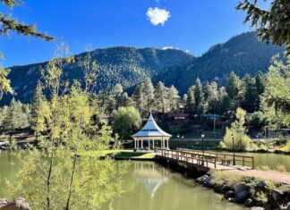 Your Creative Pikes Peak Retreat in Green Mountain Falls The green and white gazebo in the middle of the lake at Green Mountain Falls creates an idyllic scene with fall colors and the foothills of Pikes Peak on the horizon
