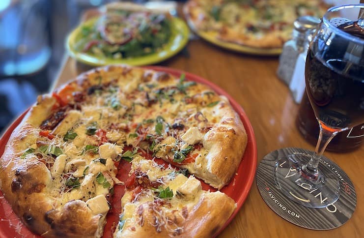 A wood-oven pizza and glass of wine at Il Vicino restaurant in Colorado Springs.