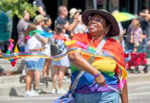 A woman marches in the Pikes Peak Pride Fest parade in Colorado Springs