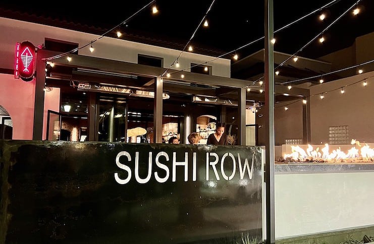 String lights and a fire pit illuminate the front of Sushi Row restaurant in Colorado Springs