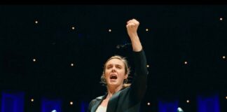 A woman conducts an orchestra in a still photo from the documentary film Maestra.