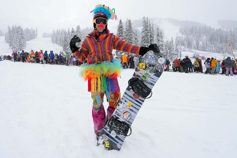 Snowboarder with a colorful costume at the Arapahoe Basin opening, the first of the Colorado ski season 2023-2024