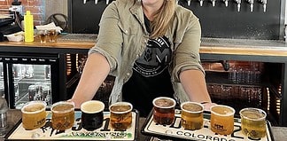 A woman bartender at Mash Mechanix, one of the best breweries in Colorado Springs
