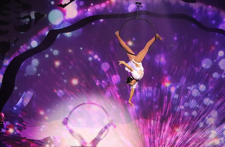 An aerialist in Cirque Musica hangs from a ring, bringing spectacular holiday entertainment in the touring show