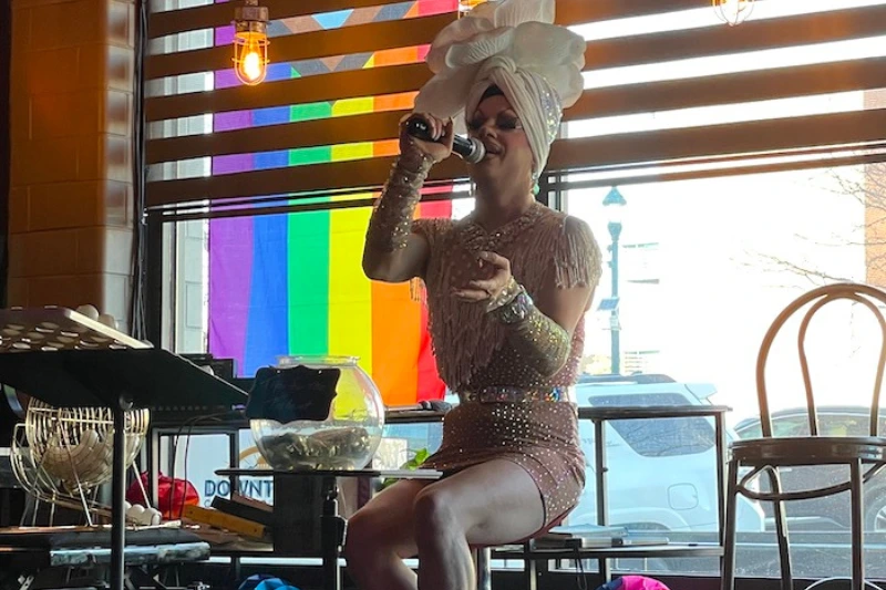 ICONS Drag Queen reading out the numbers for bingo.