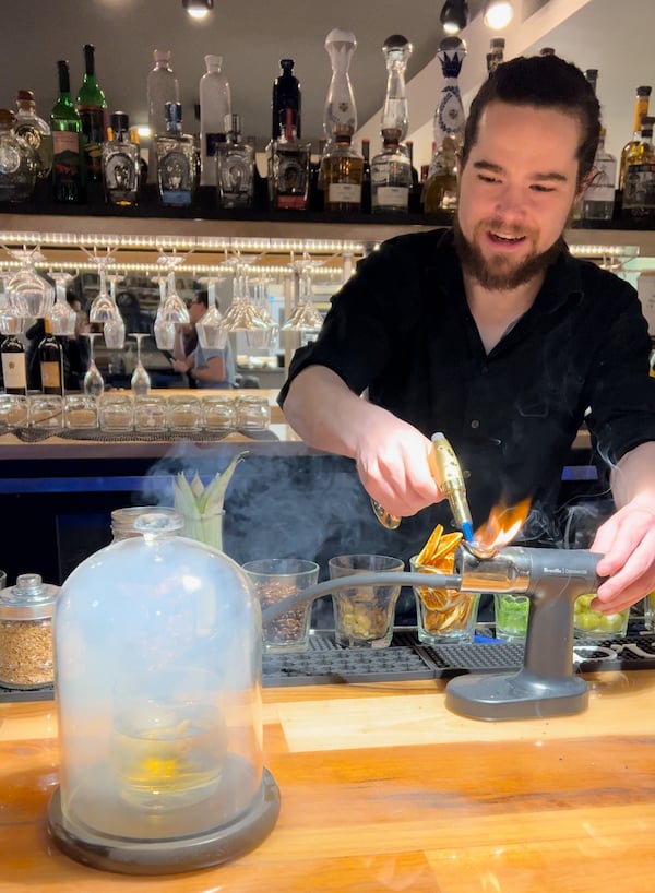 Bartender creates a smoked cocktail at Inefabe, a new fine dining Mexican restaurant in Colorado Springs