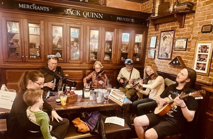A group of musicians plays in a Celtic jam session at Jack Quinn's Irish pub, just another reason it's one of the best Irish pubs in Colorado Springs