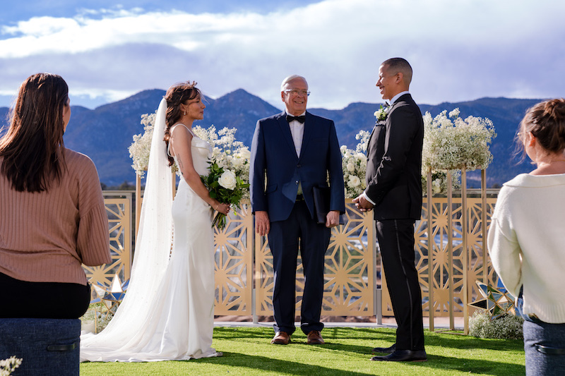 A wedding ceremony at Hotel Polaris in Colorado Springs with U.S. Air Force Academy in the background.