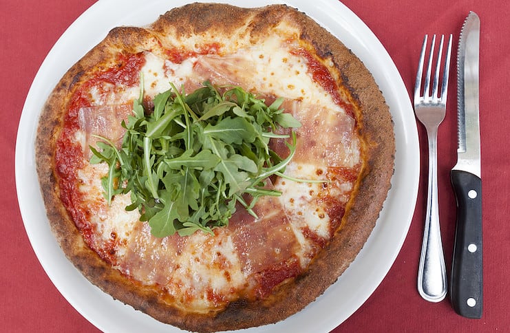 Pizza topped with fresh arugula from Pizzeria Rustica.
