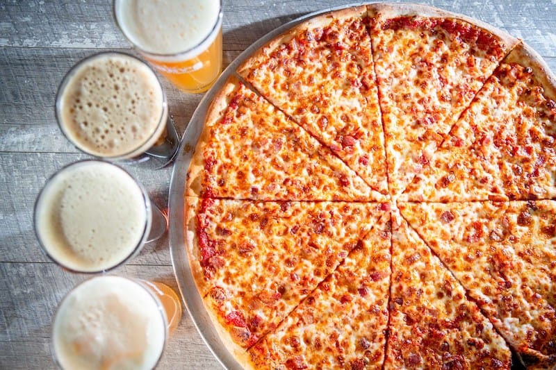 Enjoy a slice of pizza and an ice cold beer from Parry's. Photo by Parry's Pizzaeria &amp; Taphouse.