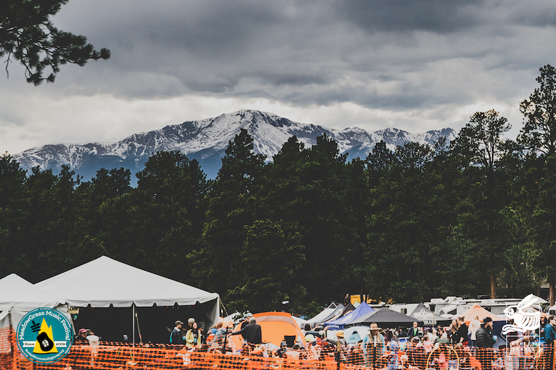 Pikes Peak beyond the MeadowGrass Music Festival stage and lawn.