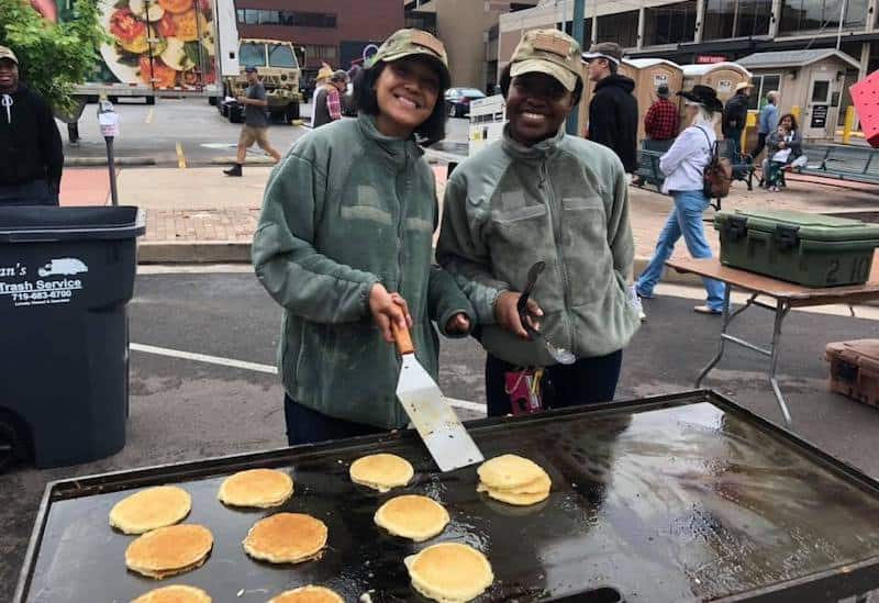 Soldiers from Fort Carson serve pancakes at the Western Street Breakfast in Colorado Springs.