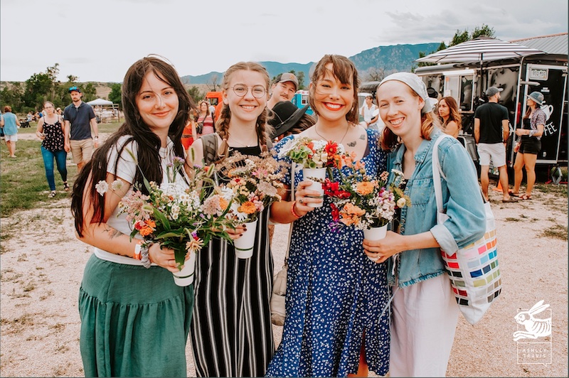 Four young women hold bouquets at Rocky Mountain Flower Fest.