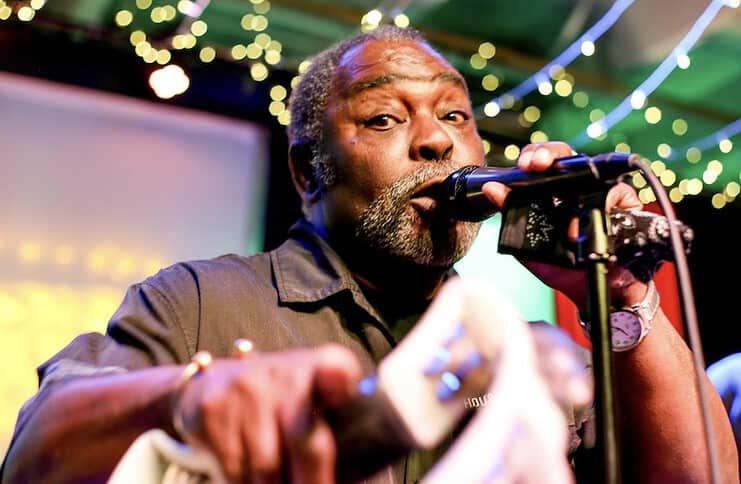 Blues singer Rex Peoples points at the camera while playing the blues. The Colorado artist will perform at Blues on the Mesa in Colorado Springs..