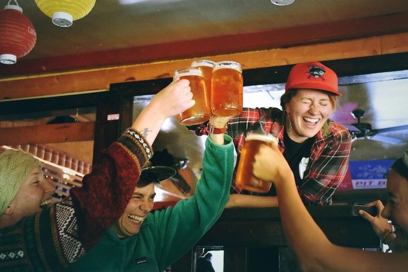 Friends raise a toast to victory at trivia night in Colorado Springs