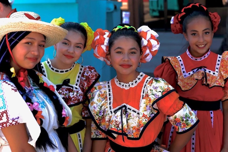 Girls in colorful, traditional Latin American dresses at the Fiestas Patrias festival, one of the best thing to do in Colorado Springs this weekend