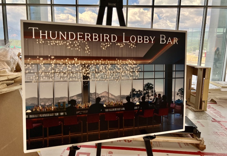 A rendering of a complete Thunderbird Lobby Bar stands in front of large windows during construction of the Hotel Polaris at the U.S. Air Force Academy.