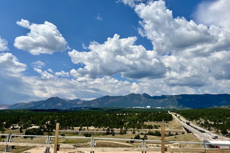View of the mountains and U.S. Air Force Academy from the patio of Aviators Rooftop Bar during construction. 