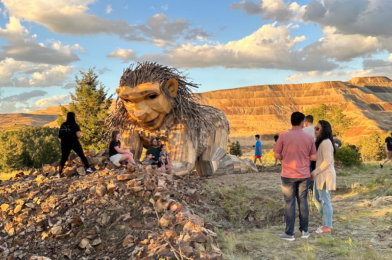 People admire Rita the Rockplanter troll in Victor, Colorado