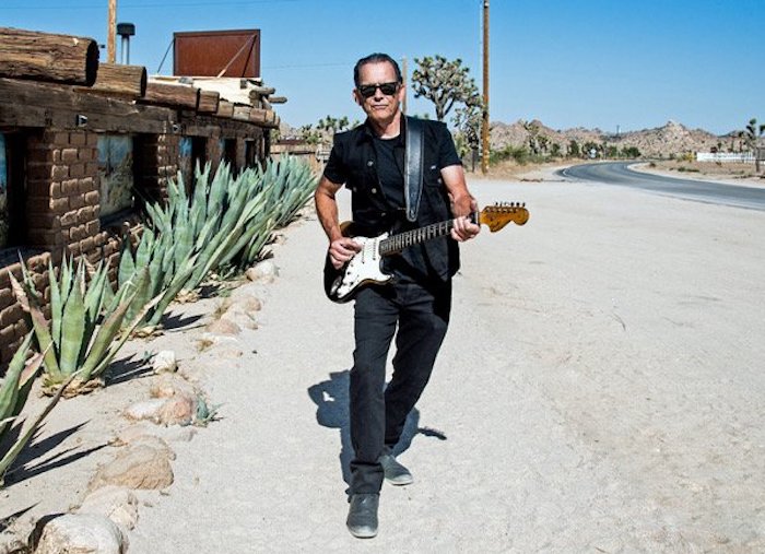 Musician Tommy Castro plays an electric guitar on the road side. He will perform at Blues on the Mesa festival in Colorado Springs.