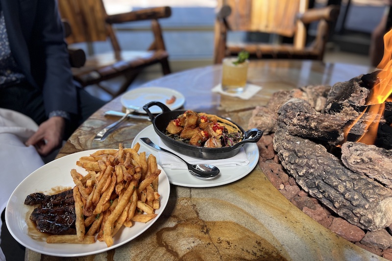Steak frites and potatoes bravas beside the fireplace at Cowboy Star in Colorado Springs.