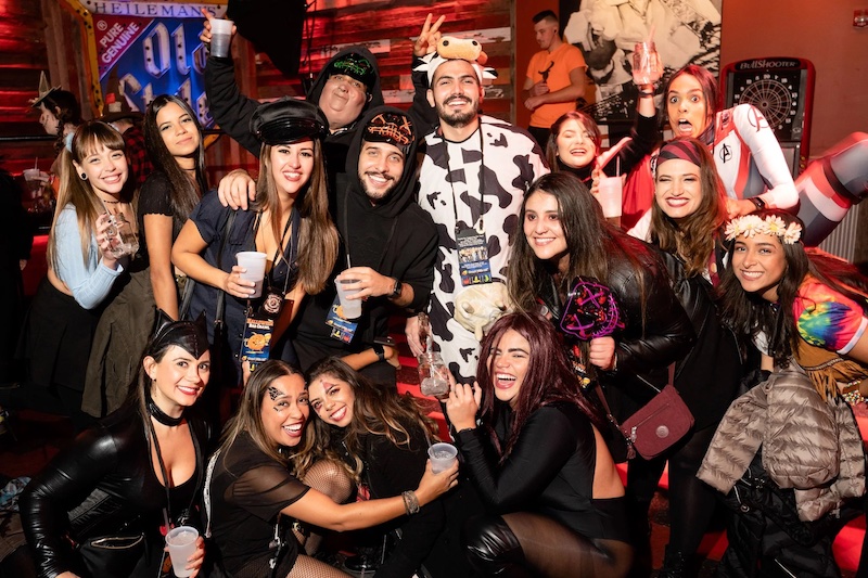 A large group of party goers in Halloween costumes for the Halloween Bar Crawl. 
