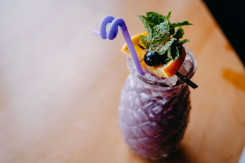 Purple ube painkiller cocktail garnished with mint at 503W in Colorado Springs.