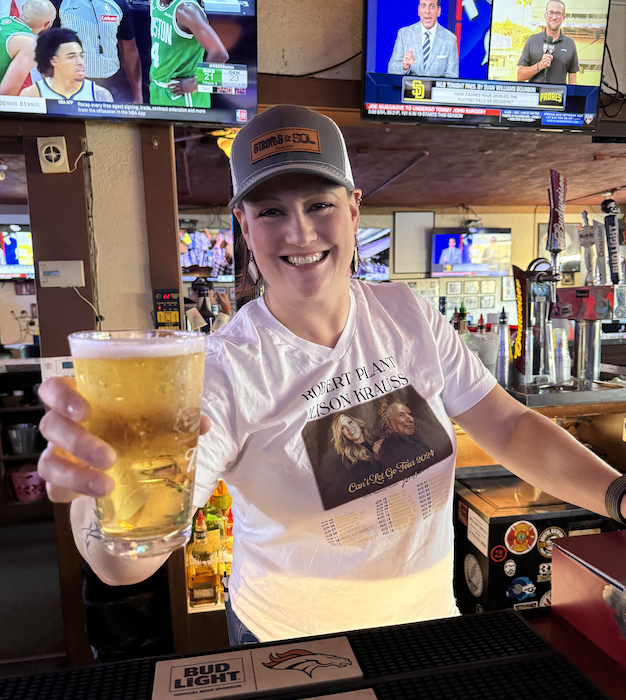 Jamie the bartender at Benny's serving a beer during happy hour at the best dive bar