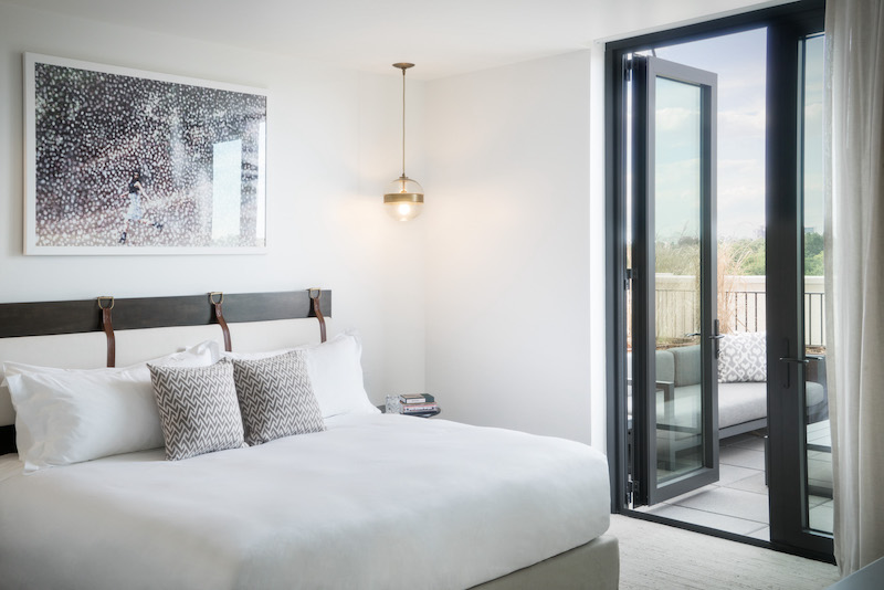 Bed and interior of a guest room at the Halcyon, a hotel in Cherry Creek
