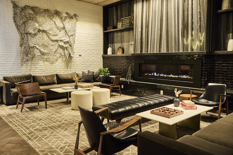 A cozy modern fireplace and living room furniture in the lobby of the Halcyon