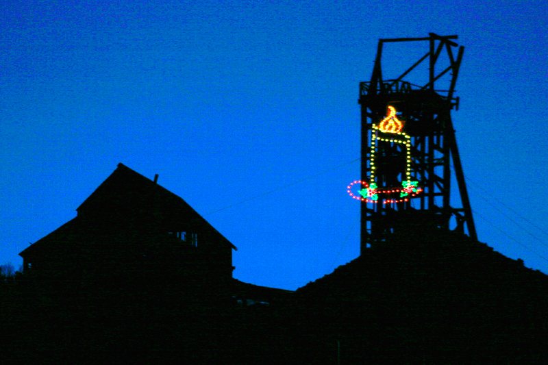 Holiday lights brighten a historic mining head frame near Victor and Cripple Creek. 