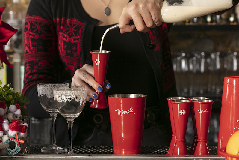 A bartender pours into a mixing glass at the Miracle pop-up bar at Jax in Colorado Springs.