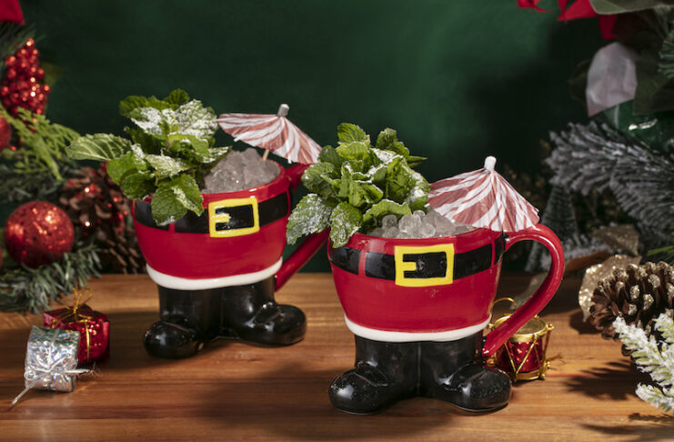 Two tiki cocktails in Santa pants mugs at the Miracle pop-up bar at Jax Fish House.