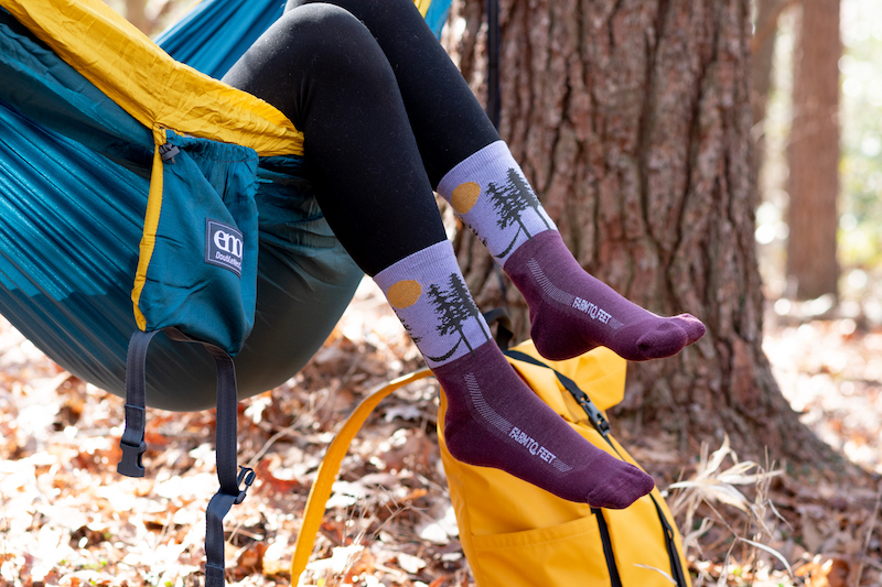 A pair of feet wearing Farm to Feet Ashville design Outdoor Trail socks