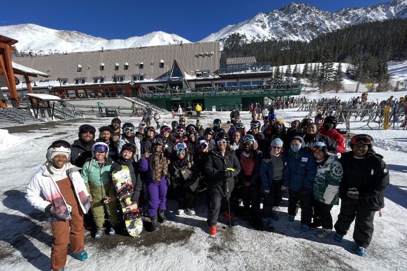 A group of Black skiers on a trip with Blackpackers. The organization gives back to the community by providing access to the outdoors to underserved communities.