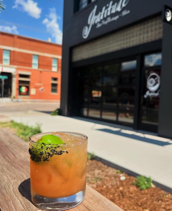 A mocktail in front of Gratitude zero-proof bar in Colorado Springs