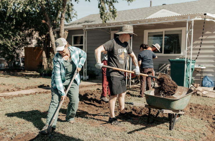 Volunteers with nonprofit Hey Neighbor plant a community garden in Colorado Springs. The group is part of the Give Campaign in 2025.