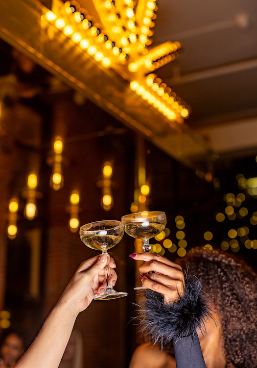 Champagne glasses clink in a New Year's toast at the Mining Exchange hotel in downtown Colorado Springs.