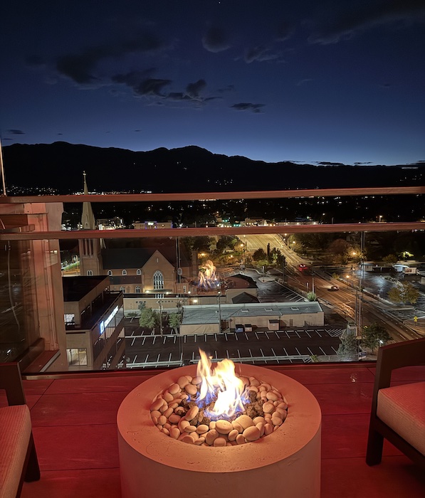 Sunset view from a fire pit at the rooftop Ryze Skyline Lounge in downtown Colorado Springs.