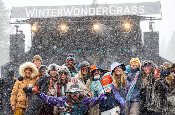 A concert crowd in the snow at Winter WonderGrass, one of the best fun things to do in Colorado mountain towns in winter