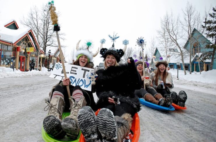 Sledders in Viking helmets on the streets of Breckenridge during Ullr Fest.