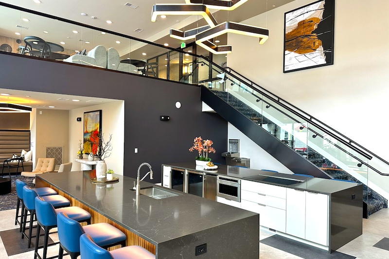Kitchen bar and open staircase in one of the common rooms at the Experience at Epicenter apartments in downtown Colorado Springs.