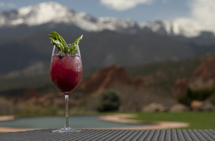 A nonalcoholic mocktail at Grand View Dry Bar with Pikes Peak and Garden of the Gods in the background.