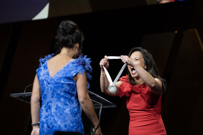 A woman presents a medal at the James Beard Awards ceremony in Chicago, 2024.