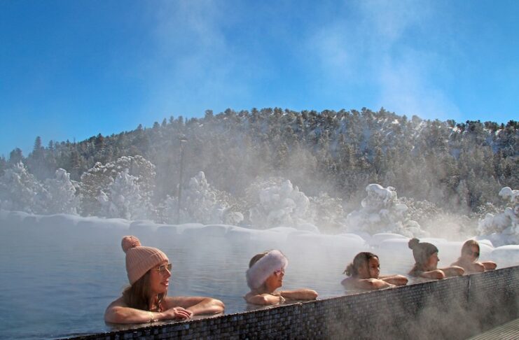 A group of women line up along the edge of the infinity pool at Mount Princeton Hot Springs Resort, one of the closest hot springs to Colorado Springs.