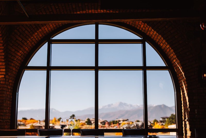 Pikes Peak view through the arch window at the Steakhouse at Flying Horse.