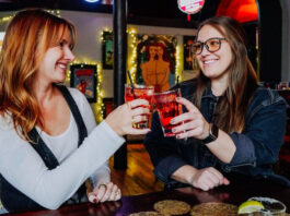 How to Celebrate Galentine’s Day in the Springs Two women cheers glasses at Mother Muffs, one of our picks for Galentine's Day karaoke